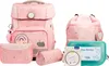 A collection of pink school supplies with rainbow motifs, including a backpack, drawstring bag, pencil case, and lunchbox. Voir les images du produit