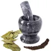 A marble mortar and pestle with bay leaves and peppercorns. Voir les images du produit