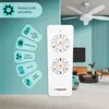 A remote control for a ceiling fan is shown in the foreground, with the ceiling fan itself visible in the background, along with a living room setting. Náhled obrázku produktu