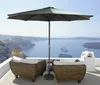 A patio umbrella and chairs on a balcony overlooking the sea. Produktbild-Vorschau