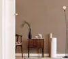 A room interior with a chair, a wooden cabinet, and a floor lamp. Produktbild-Vorschau