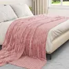 A pink fleece throw blanket is draped over a bed. Náhľad obrázku produktu