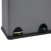 A close-up view of the bottom section of a gray trash can with two foot pedals. One pedal is yellow, and the other is green. Voir les images du produit