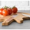 Tomatoes are placed on a guitar-shaped cutting board. Náhľad obrázku produktu