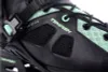A close-up view of a black and green inline skate. Anteprima dell’immagine prodotto