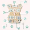 A Montessori busy board shaped like a bear, with various interactive elements and feature callouts. Produktbild-Vorschau