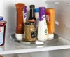 Various condiments and sauces are arranged on a rotating tray inside a refrigerator. Anteprima dell’immagine prodotto