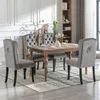 A dining room set with four chairs and a table, set on a rug. Produktbild-Vorschau