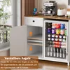 A white kitchen buffet with a glass-door mini-fridge filled with drinks and adjustable shelves in an open cabinet. Produktbild-Vorschau