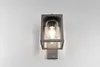 A modern outdoor wall lamp with a glass shade and a metal frame is mounted on a white wall. Anteprima dell’immagine prodotto