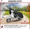 A scooter covered with a black protective cover, shown in a landscape setting with elements representing different seasons. Produktbild-Vorschau