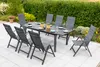 A patio set with a table and chairs in a garden setting. Produktbild-Vorschau