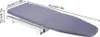 A gray ironing board with a metal sliding mechanism, shown with dimensions indicated by text and arrows. Voir les images du produit