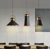 Three pendant lights hanging over a dining table. Náhled obrázku produktu