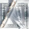 Decorative molding pieces are arranged in a triangular formation on a white surface, with sunlight casting shadows. Produktbild-Vorschau