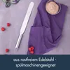 A palette knife, purple cloth, and a bowl of frosting are arranged on a gray surface, with some raspberries scattered around. Produktbild-Vorschau