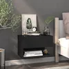 A black floating nightstand is mounted on a gray wall next to a bed. The nightstand holds decorative items and books. Produktbild-Vorschau