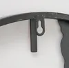 A close-up view of a metal wall clock's hanging mechanism. Podgląd zdjęcia produktu