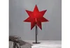 A red star-shaped lamp on a black stand. Podgląd zdjęcia produktu