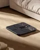 A smart body scale is placed on a wooden floor next to a bed. Náhľad obrázku produktu