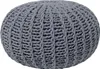 A close-up view of a round, knitted pouf. Náhled obrázku produktu