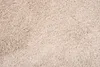 A close-up, top-down view of a beige carpet. Náhľad obrázku produktu