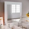 A white vanity table with a mirror reflecting a window with white curtains. Podgląd zdjęcia produktu