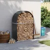 A firewood storage rack filled with wood, placed next to a white wall in a garden setting. Náhled obrázku produktu