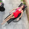 A woman relaxing on a lounge chair on a patio. Anteprima dell’immagine prodotto