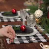 A hand holding a sparkler over a table set for a holiday meal. Náhled obrázku produktu