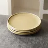 A stack of beige plates on a gray surface. Produktbild-Vorschau