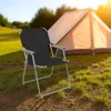 A camping chair is set up in front of a tent on a grassy field during sunset. Produktbild-Vorschau