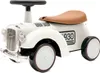 A white toy car with a brown seat and black wheels, presented on a white background. Produktbild-Vorschau