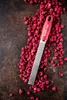 A grater is placed on a pile of dried raspberries on a dark surface. Anteprima dell’immagine prodotto