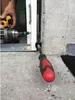 A person is using a power drill and a screwdriver to install a window or door frame component. Produktbild-Vorschau