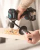 A person is using a cordless drill to drill a hole in a wooden plank, creating wood shavings. Produktbild-Vorschau