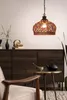 A living room scene with a pendant lamp, a cabinet, a chair, and a small table with a teapot. Podgląd zdjęcia produktu