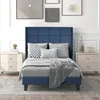 A bedroom scene with a blue upholstered bed as the focal point, flanked by two beige nightstands. Produktbild-Vorschau