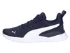 A side view of a navy blue Puma sneaker with a white stripe and white sole, set against a white background. Produktbild-Vorschau