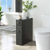 A slim black cabinet is placed next to a toilet in a bathroom, with a bathtub and window in the background. Náhled obrázku produktu