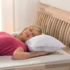 A woman sleeping on a bed with a pillow. Podgląd zdjęcia produktu