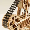 A close-up view of a wooden model film projector with film reel. Produktbild-Vorschau
