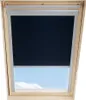 A dark roller blind is partially covering a skylight, revealing a blue sky with clouds below. Produktbild-Vorschau