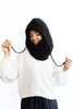 A woman wearing a white sweater and a black hooded scarf. Produktbild-Vorschau