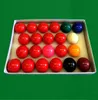 A set of billiard balls in a white box on a green felt surface. Produktbild-Vorschau