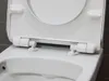 A close-up view of the hinges and seat of a white toilet. Produktbild-Vorschau