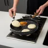 A person is cooking pancakes on a stovetop in a kitchen. Produktbild-Vorschau