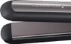 A close-up shot of a black and gray hair straightener with the brand name 'REMINGTON' visible on the top plate. Podgląd zdjęcia produktu