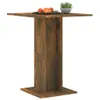 A square wooden table with a pedestal base, shown against a white background. A plate of fruit and a small potted plant are on the table. Produktbild-Vorschau