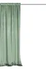 A green velvet curtain hanging from a rod against a white background. Podgląd zdjęcia produktu